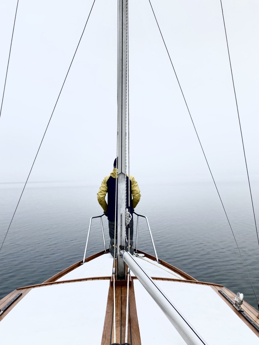 Someone sitting in front of a ship into misty weather